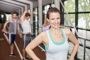 Smiling athletic woman posing with hands on hips