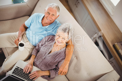 Senior woman using laptop in living room