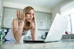 Pretty blonde woman looking at laptop