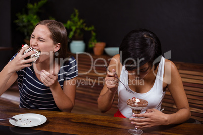 Pretty women eating desserts