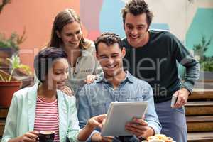 Happy friends using tablet