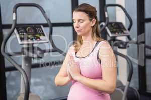 Peaceful pregnant woman with hands together