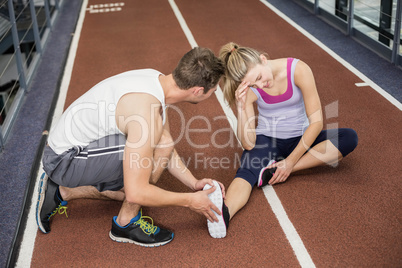 Muscular woman having an ankle injury