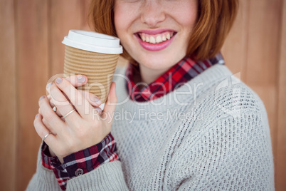 smiling hipster woman holding a coffee cup
