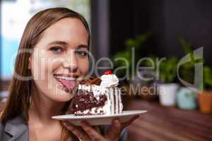Sweet tooth woman holding piece of cake