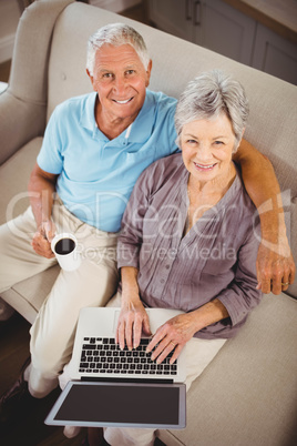 Senior woman using laptop in living room