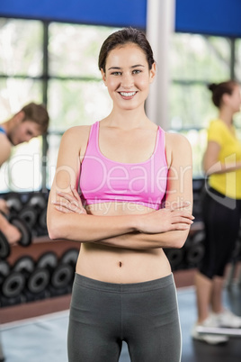 Fit woman posing with athletic women and man behind
