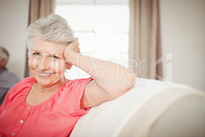 Happy senior woman sitting on sofa