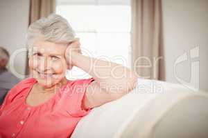 Happy senior woman sitting on sofa