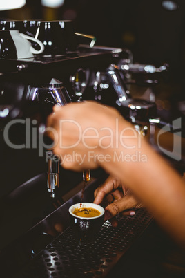 Waiter making a cup of coffee