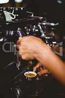 Waiter making a cup of coffee