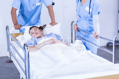 Doctors standing near patient bed