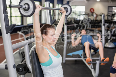 Fit woman lifting barbell