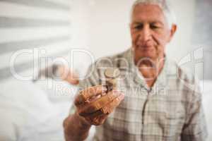 Senior man looking at a pill bottle