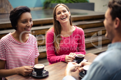 Happy friends having coffee together