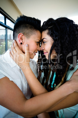 Lesbian couple embracing each other and smiling