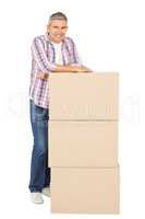 Happy man posing with moving boxes