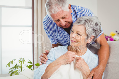 Senior man embracing woman at home