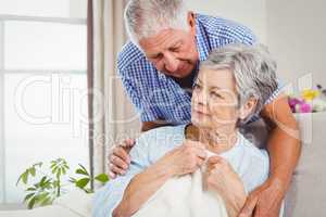 Senior man embracing woman at home