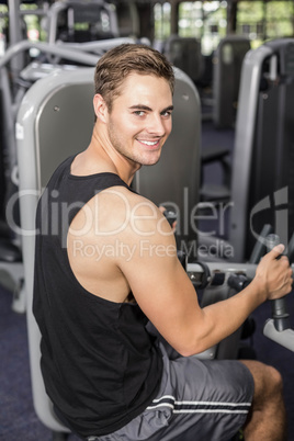 Fit man using weight machine