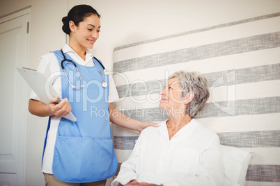 Nurse taking care of sick senior woman
