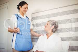 Nurse taking care of sick senior woman