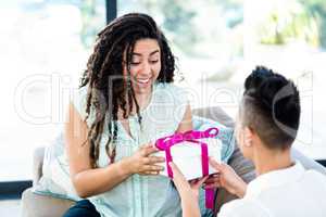Woman receiving a gift from her partner