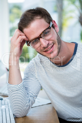 Handsome man working resting on his desk Handsome man working resting on his desk