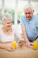 Happy senior couple listening to music