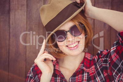 smiling hipster woman  wearing a trilby and sunglasses