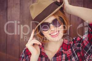 smiling hipster woman  wearing a trilby and sunglasses