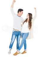 Triumphant couple raising fist