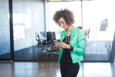 Young woman using mobile phone in office