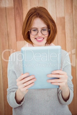 Red haired hipster using tablet