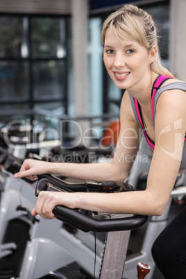 Fit woman on exercise bike