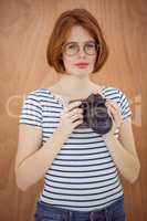 smiling hipster woman holding a digital camera