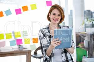 smiling hipster woman typing on her tablet