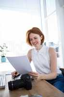 smiling hipster business woman reading files