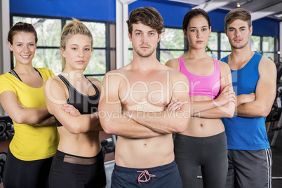 Athletic men and women posing with arms crossed