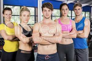 Athletic men and women posing with arms crossed