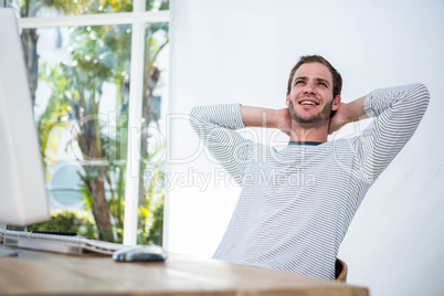 Handsome businessman relaxing on his desk chair