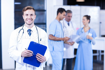 Doctor holding medical report and smiling at camera