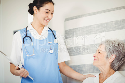 Nurse taking care of sick senior woman