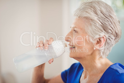 Happy senior woman drinking water