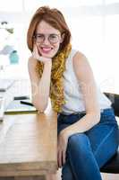 beautiful hipster business woman leaning on her desk