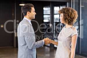 Businessman shaking hands young woman