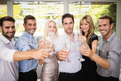 Group of friends holding glasses of champagne