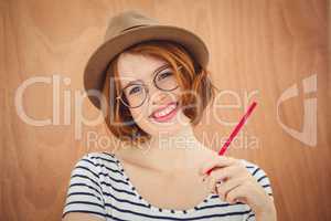 Smiling hipster woman holding a pen