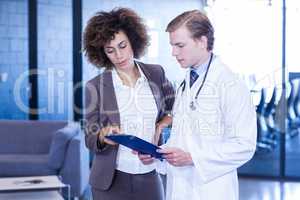 Doctor and colleague looking at medical report