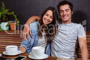 Smiling couple drinking coffee